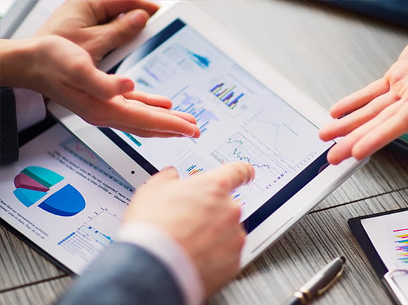 Two people going through website performance figures together after an SEO audit