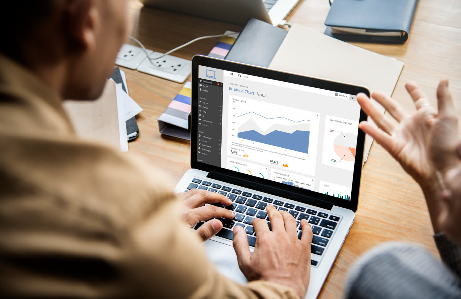 Two people going through a website performance dashboard on a laptop during an SEO audit